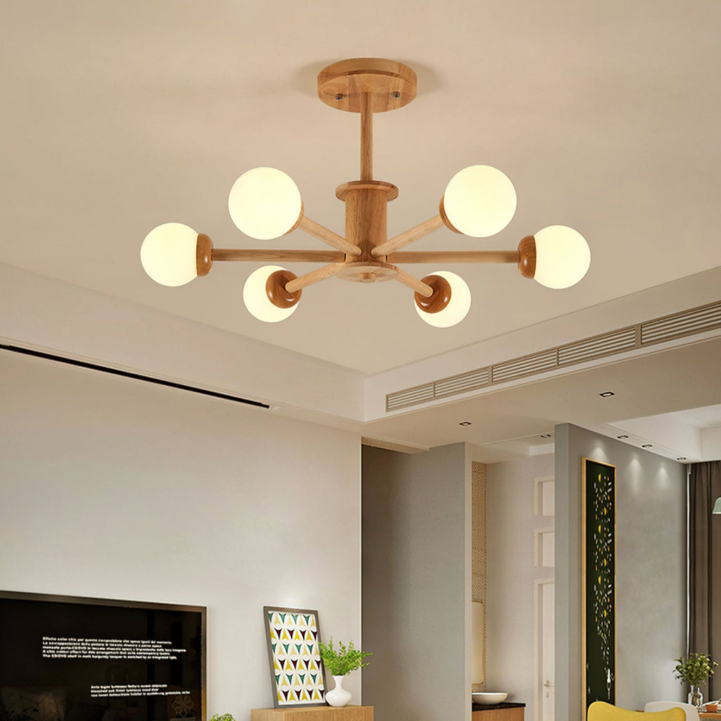 Six-globe ceiling light from Clérachic in a light wood finish, lit warm in a living room with a television and a framed print.