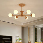Six-globe ceiling light from Clérachic in a light wood finish, lit warm in a living room with a television and a framed print.
