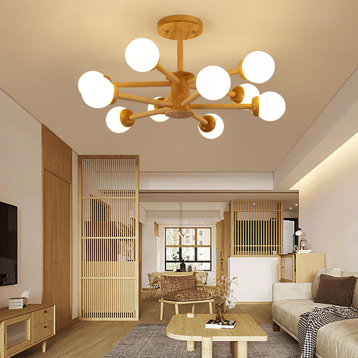 Wood and white Clérachic ceiling light with its globes glowing, above a living room with a slatted partition and a woven rug.