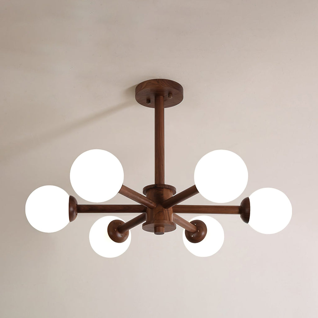 Walnut Clérachic ceiling light seen from below, with six white globes on dark wooden arms, against a soft taupe ceiling.