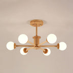Light wood Clérachic ceiling light with six white globes on straight arms and a round wooden canopy, on a taupe ceiling.