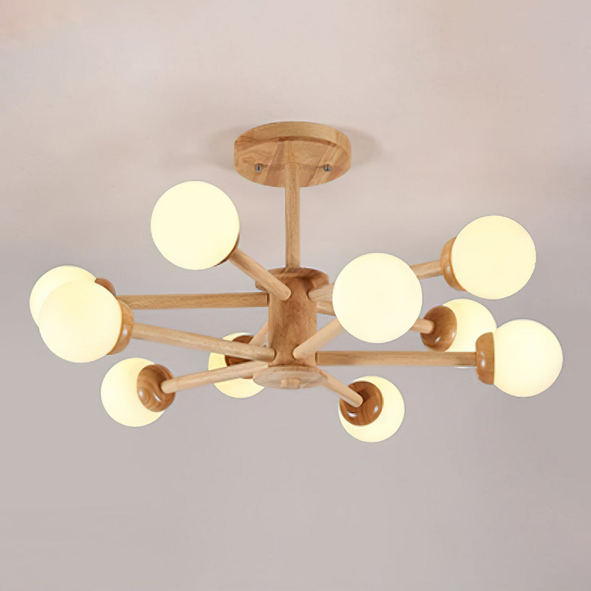 Wood and white Clérachic ceiling light with ten globes on branching pale arms, seen from below on a grey-pink ceiling.