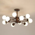 Walnut Clérachic ceiling light with a dozen white globes on dark branching arms, pictured against a warm grey ceiling.