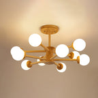 Light wood Clérachic ceiling light with ten globes lit on branching arms, set against a warm golden ceiling.