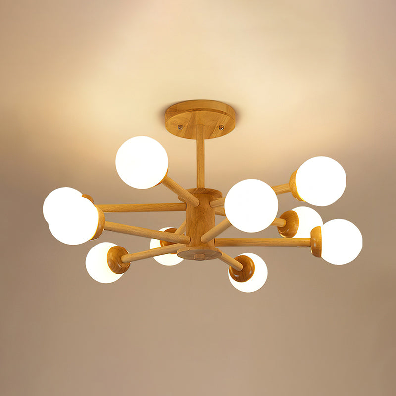 Light wood Clérachic ceiling light with ten globes lit on branching arms, set against a warm golden ceiling.