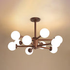 Walnut ceiling light from Clérachic with white globes bunched around a dark wooden stem, against a warm ceiling.