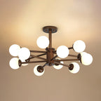 Twelve-globe walnut and white Clérachic ceiling light with layered dark arms, lit against a honey-toned ceiling.