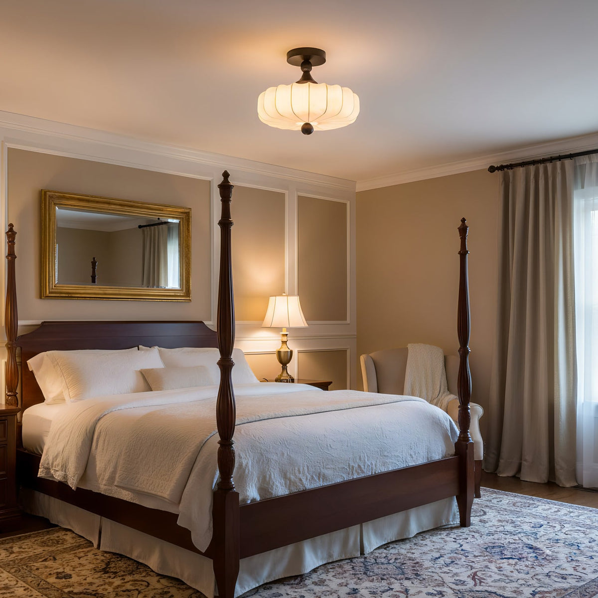 Above a dark four-poster bed, a lit Clérachic ceiling light with a pleated fabric shade casts a warm glow over a room with a gold mirror.