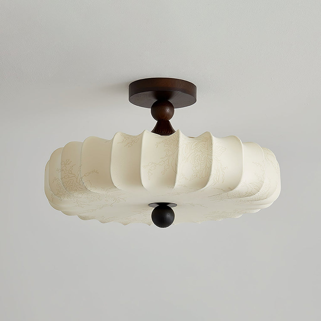 Switched off, this Clérachic ceiling light shows its cream fabric shade with a faint printed pattern, a dark canopy and a round wooden finial.