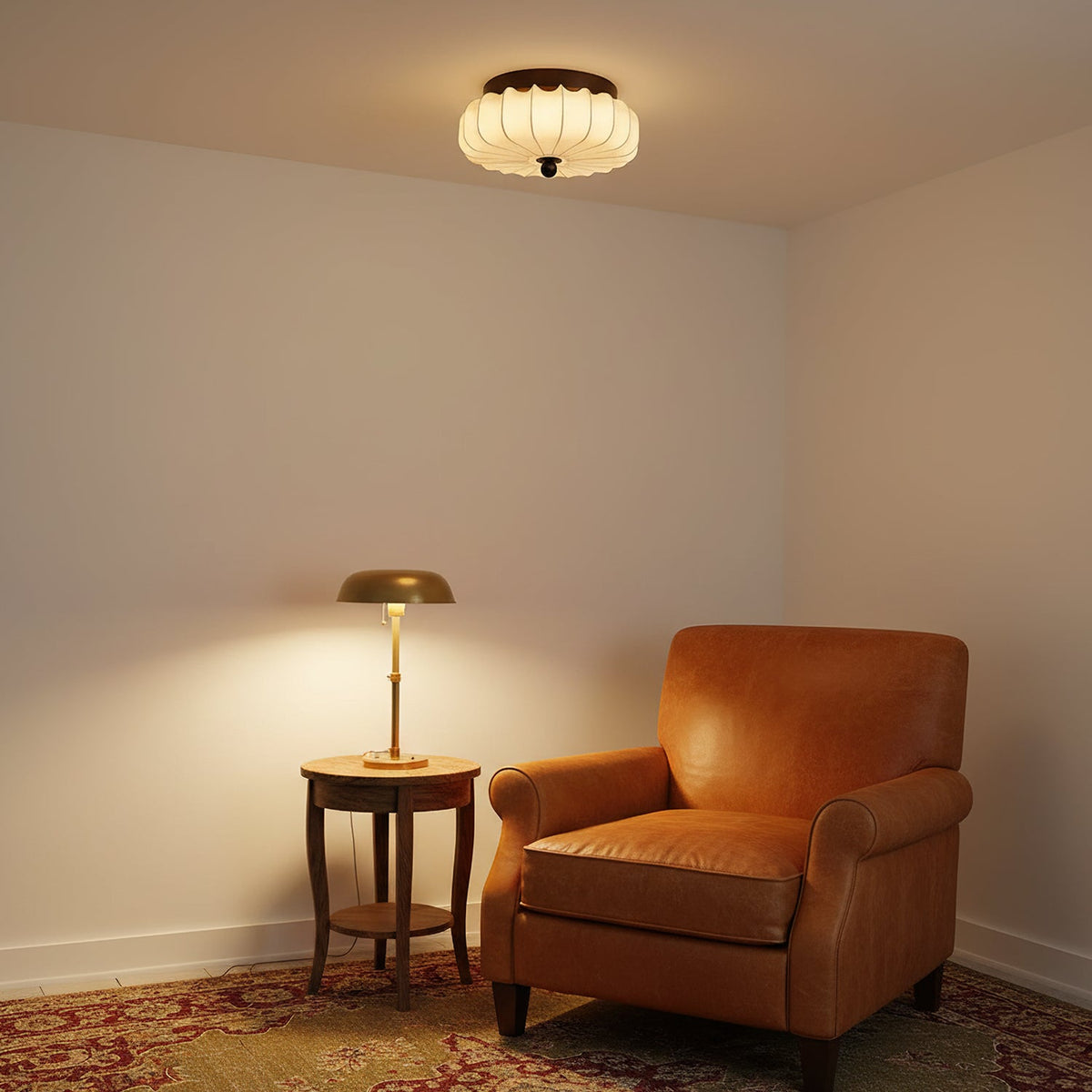 This Clérachic ceiling light glows in a corner with a tan leather armchair and a brass table lamp on a round side table.