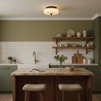 Above a kitchen with a wooden island, open shelves and sage-green cabinets sits this pleated fabric Clérachic ceiling light.