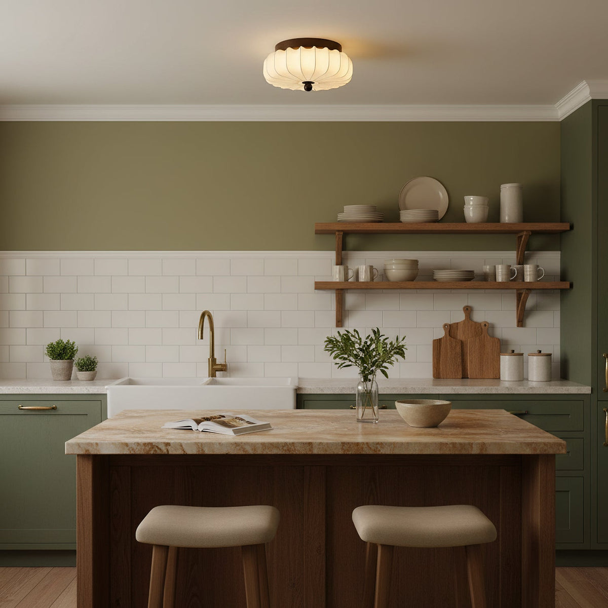 Above a kitchen with a wooden island, open shelves and sage-green cabinets sits this pleated fabric Clérachic ceiling light.