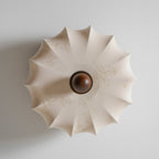 View from directly below of the folded fabric shade, with a floral print, on this Clérachic ceiling light.