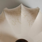 Close view of the folded edge and floral print on the fabric shade of this Clérachic ceiling light.