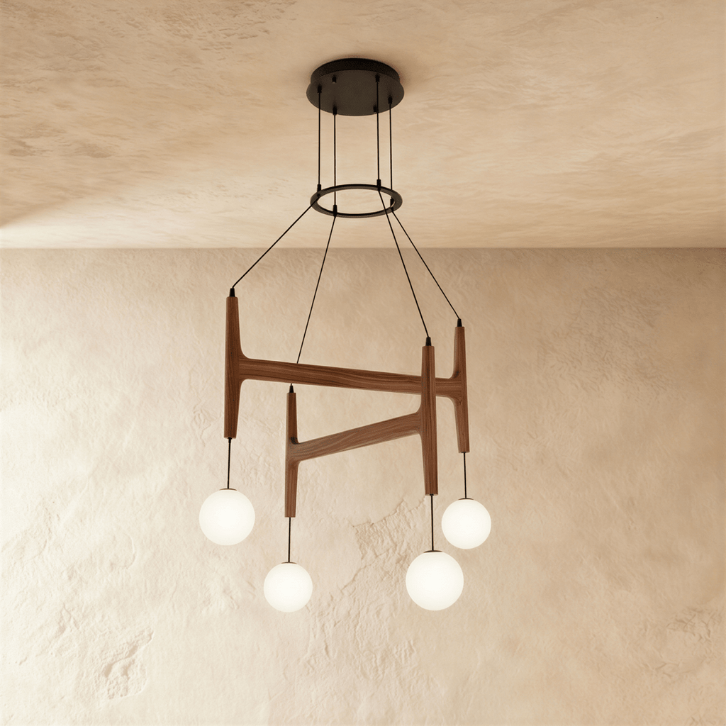 Clérachic's chandelier in dark red mahogany wood, four frosted glass globes hanging from its branching frame.
