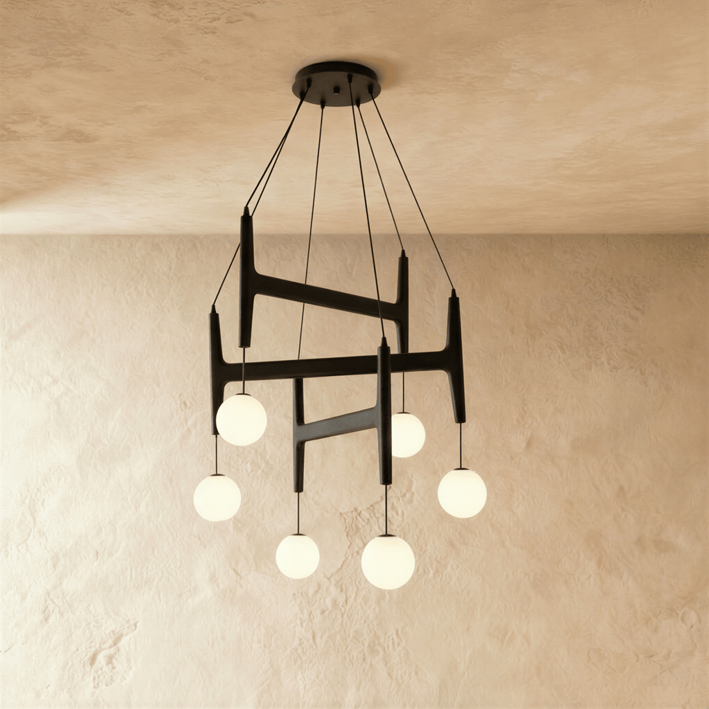 Clérachic's chandelier in black walnut wood, six frosted glass globes suspended from its layered frame.