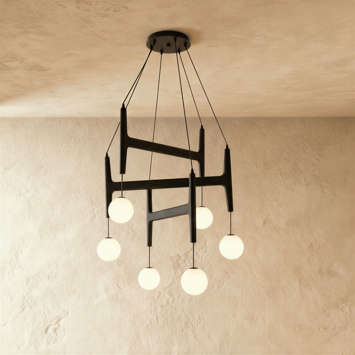 Clérachic's chandelier in black walnut wood, six frosted glass globes suspended from its layered frame.