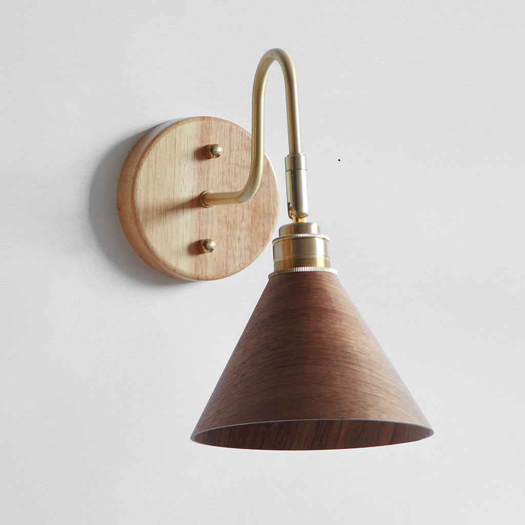 Close view of the light wood backplate, brass gooseneck and walnut-colour cone shade of this Clérachic wall light.