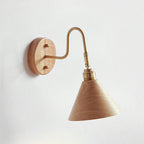 Wood-colour cone shade on a brass gooseneck arm with a light wooden backplate, this Clérachic wall light on a pale wall.