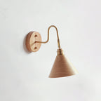 Side-on view of a wood-colour cone shade and brass gooseneck arm on a Clérachic wall light against a pale wall.