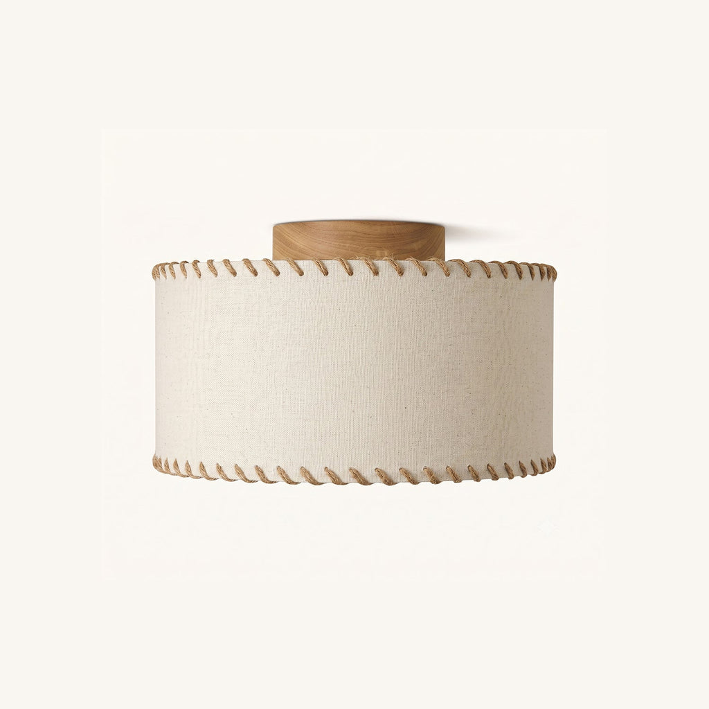Clérachic flush-mount ceiling light with a beige linen drum shade, rope-stitched edges and a round wood canopy, on a plain white backdrop.