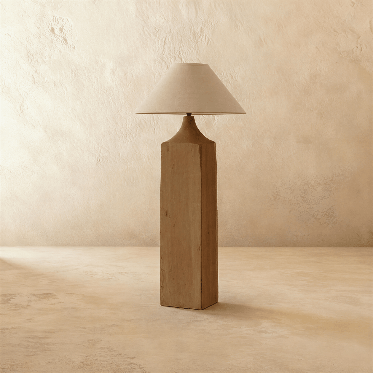 Clérachic floor lamp with a square raw-grain wooden post, a tapered wood neck and a wide natural linen cone shade, unlit, on limewash.