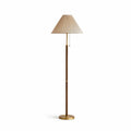 Clérachic floor lamp on a white backdrop, with the pleated beige shade, thin walnut-toned stem, brass collar, pull chains and brass base.