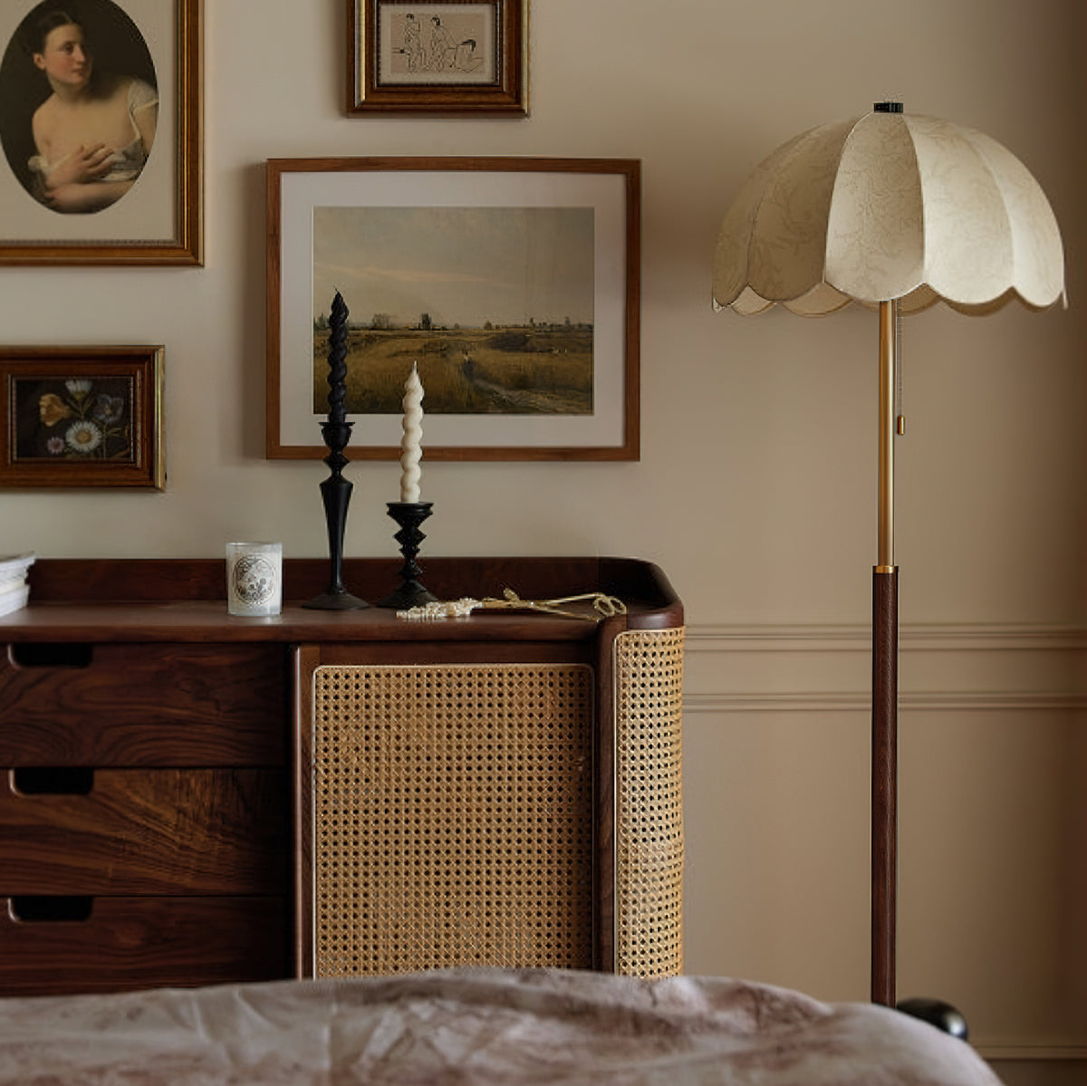 Unlit Clérachic floor lamp with a cream scalloped shade, set by a walnut sideboard with a rattan door and framed landscape pictures.