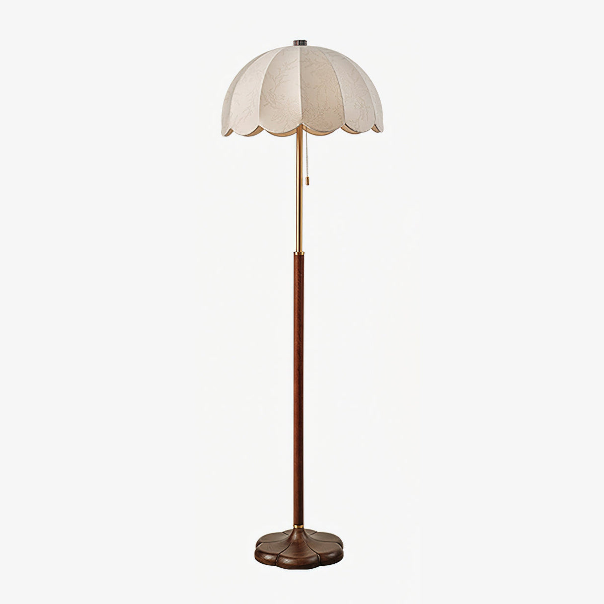 Full-length Clérachic floor lamp on a pale grey backdrop, showing its scalloped fabric shade, brass neck, walnut stem and round base.