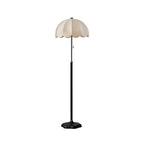 Clérachic floor lamp in a black-stemmed version with a white scalloped shade and black base, on a white backdrop.