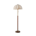 Cut-out view of this Clérachic floor lamp with a walnut-toned stem, brass neck and white scalloped shade, on a white backdrop.