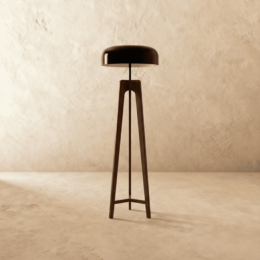 Clérachic tall dark wood tripod floor lamp with a black disc shade switched off, against a limewash wall.