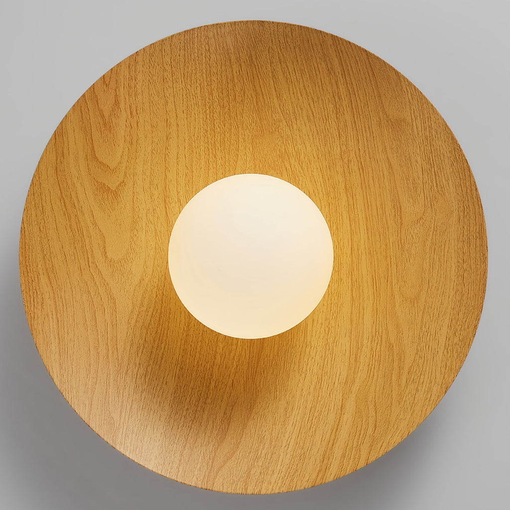 Looking straight up at the underside of this Clérachic ceiling light, a natural wood-grain disc frames the frosted white globe.