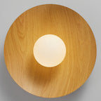 Looking straight up at the underside of this Clérachic ceiling light, a natural wood-grain disc frames the frosted white globe.