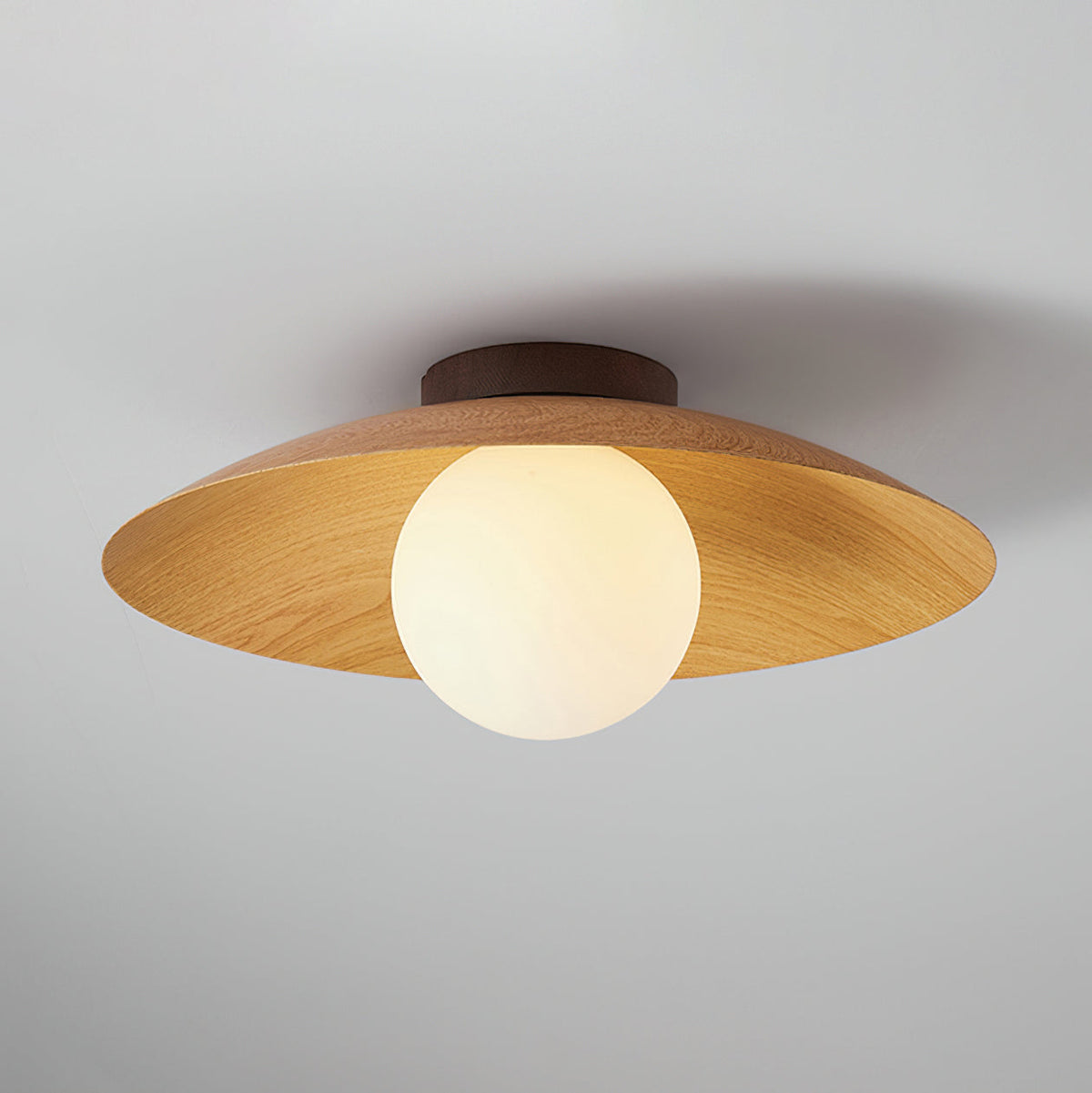 This Clérachic ceiling light in a natural wood-grain finish hangs a frosted globe under a wide shade, against a soft grey backdrop.