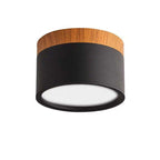 Clérachic Wood-Grain Cylinder Ceiling Light in black, seen from below where the wood-grain collar meets the matte body.