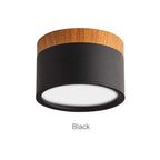 Clérachic Wood-Grain Cylinder Ceiling Light in Black, the deep matte finish contrasting with the wood collar.
