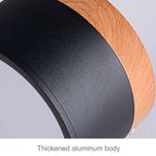 Close-up of the Clérachic Wood-Grain Cylinder Ceiling Light's thickened aluminium body where black meets the wood-grain collar.