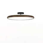 Dark walnut-grain ring on a black canopy, this Clérachic ceiling light seen from the side on a white backdrop.