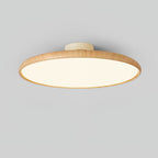 Light wood-grain Clérachic ceiling light with a lit white diffuser, shown from below at an angle against a grey backdrop.