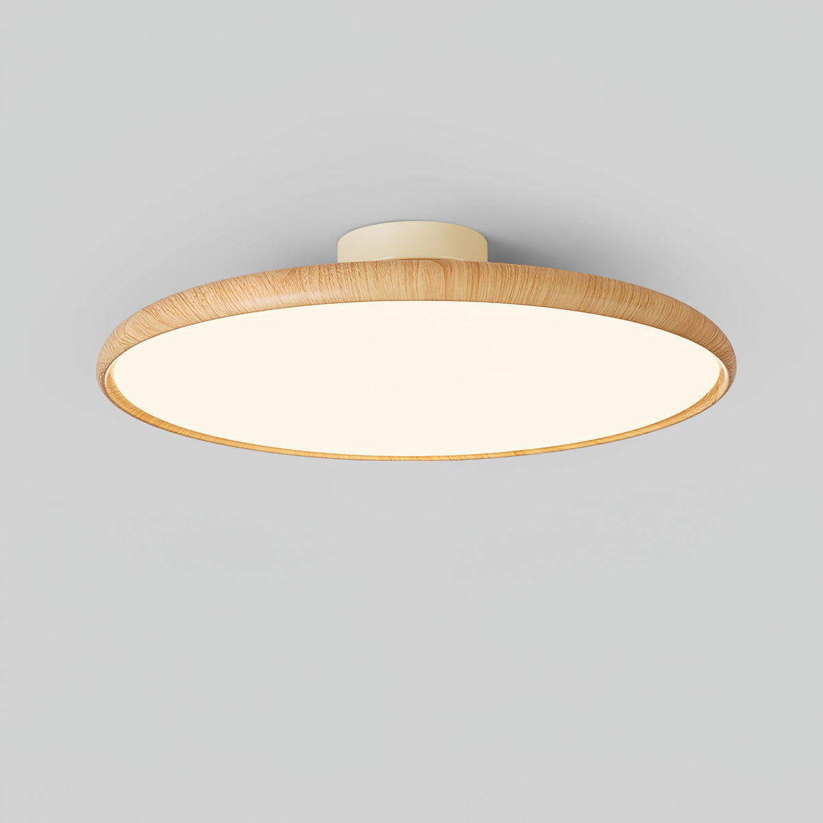 Light wood-grain Clérachic ceiling light with a lit white diffuser, shown from below at an angle against a grey backdrop.