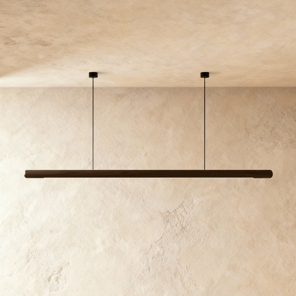 Clérachic's black walnut wood pendant bar hangs level from two thin cables against a plaster wall.