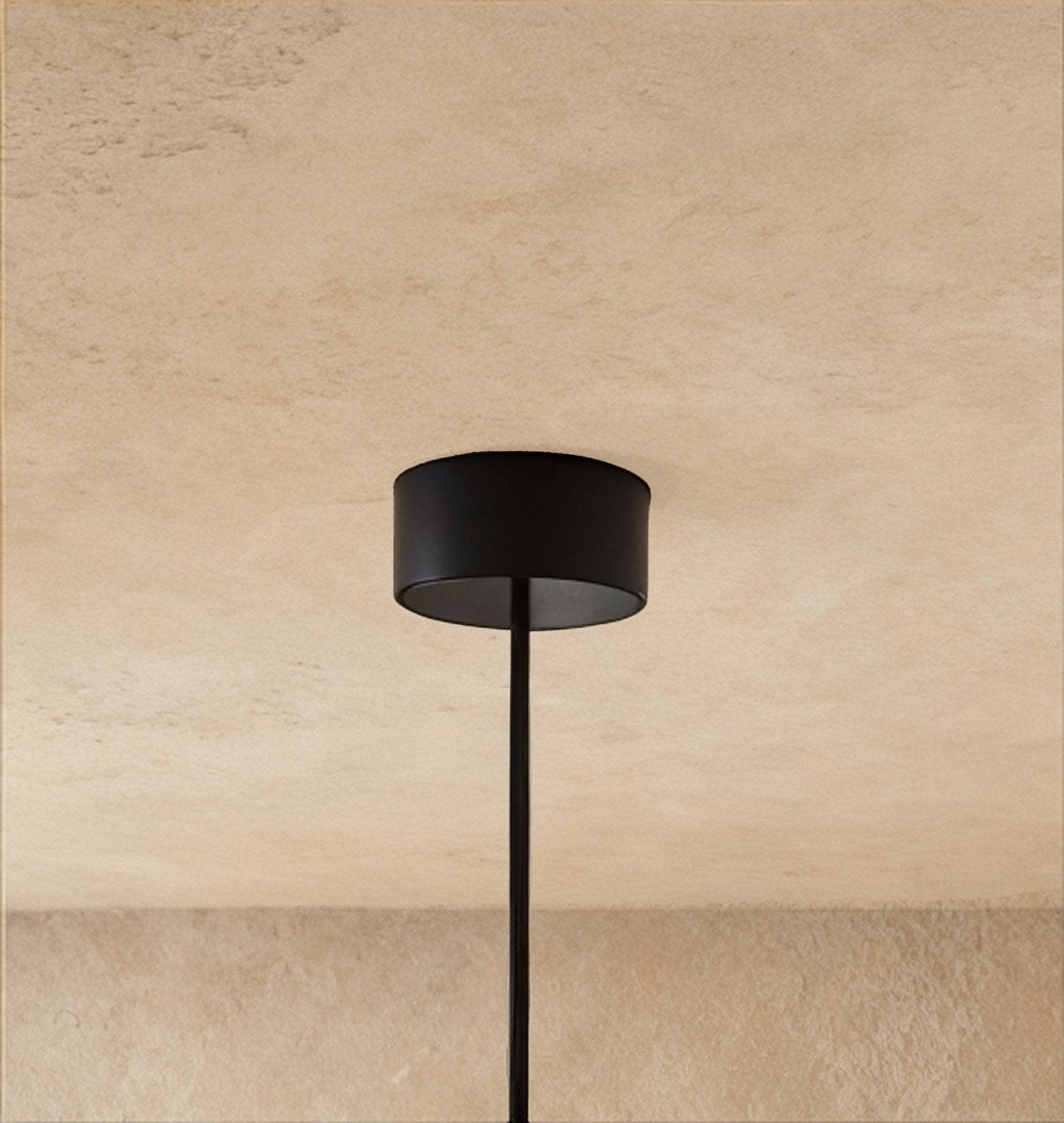 A close view shows the Clérachic pendant's black drum-shaped ceiling canopy and its single thin cable.