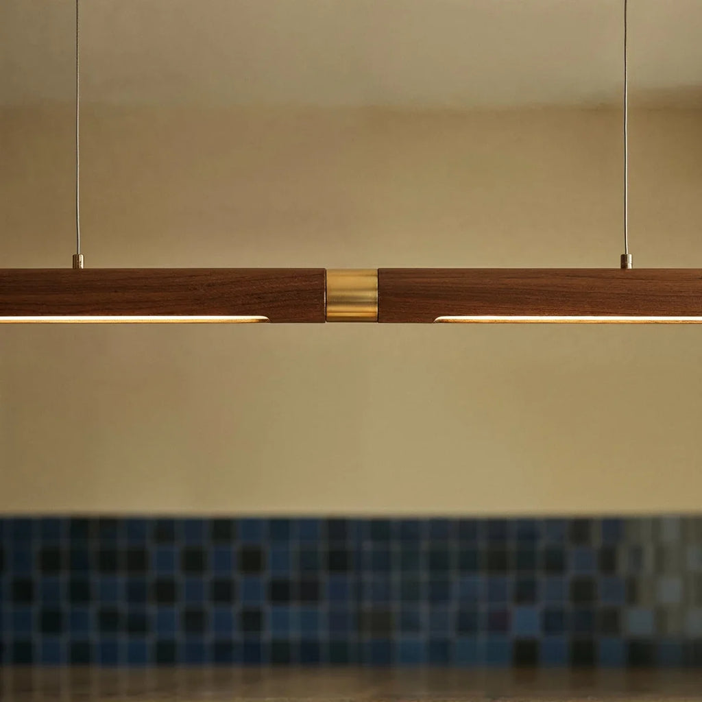 A close view shows the brass center joint on the long Clérachic black walnut pendant bar's wood run.