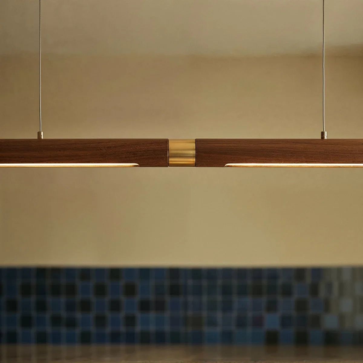 A close view shows the brass center joint on the long Clérachic black walnut pendant bar's wood run.