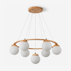 Seven frosted white glass globes hang from a light wood ring on fine wires and a round wood ceiling plate, on this Clérachic chandelier.