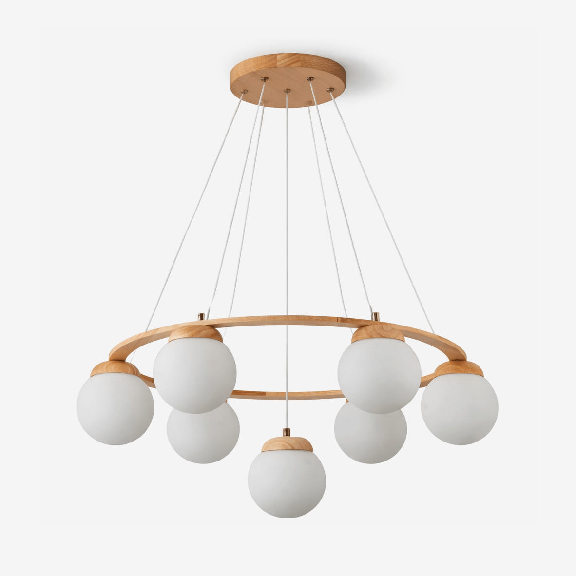 Seven frosted white glass globes hang from a light wood ring on fine wires and a round wood ceiling plate, on this Clérachic chandelier.
