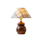 A Clérachic table lamp with a plaid fabric shade and a rounded wood base, cut out on a plain white background.