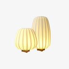 Two glowing ribbed fabric lamps, one tall and one round, on a plain light backdrop, this Clérachic set seen from slightly above.