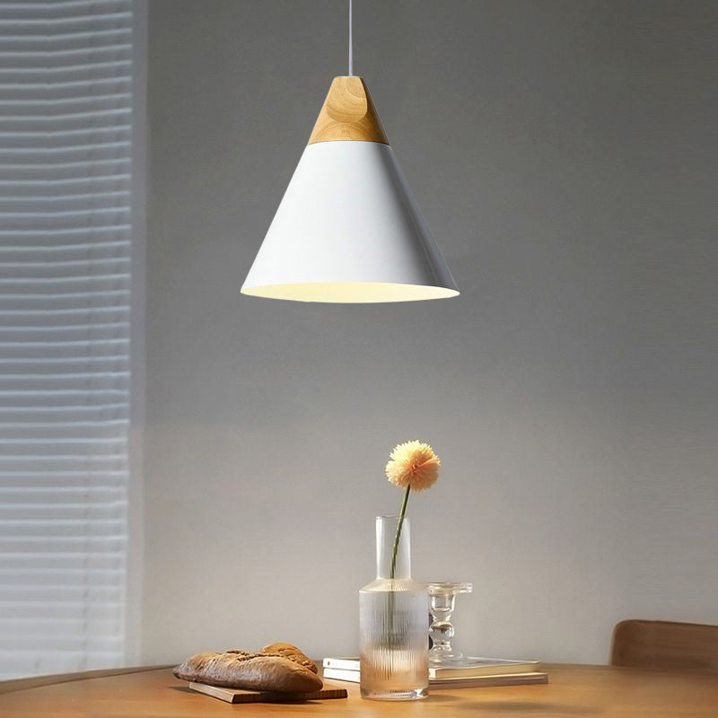 This wide white Clérachic cone pendant is shown head-on, lit above a wooden table beside a slatted blind.
